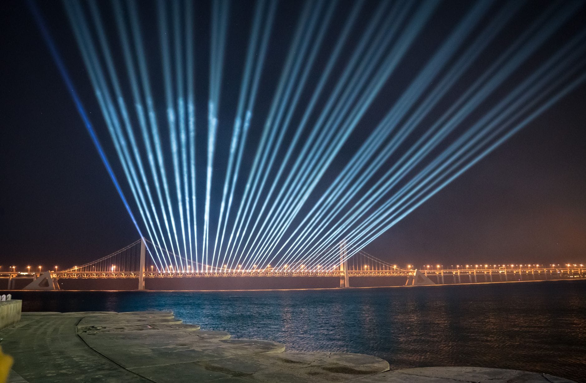 Nocny pokaz laserowy nad mostem w Dalian w Chinach